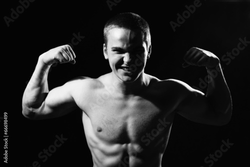 Muscular guy shows biceps © kanzefar