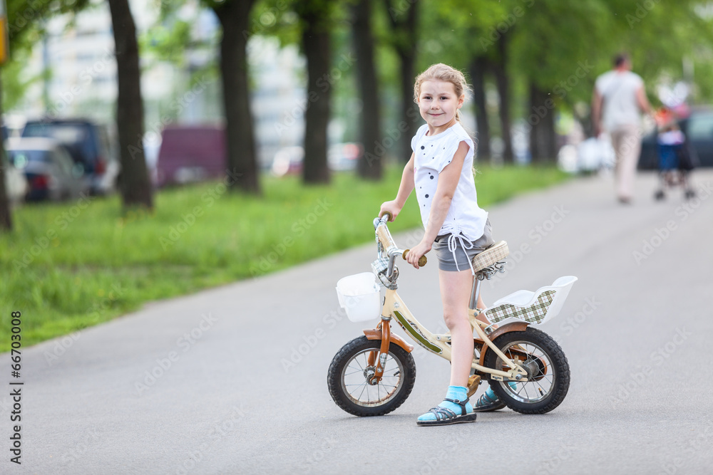 Small Caucasian girl riding a bicycle Small Caucasian girl riding a bicycle