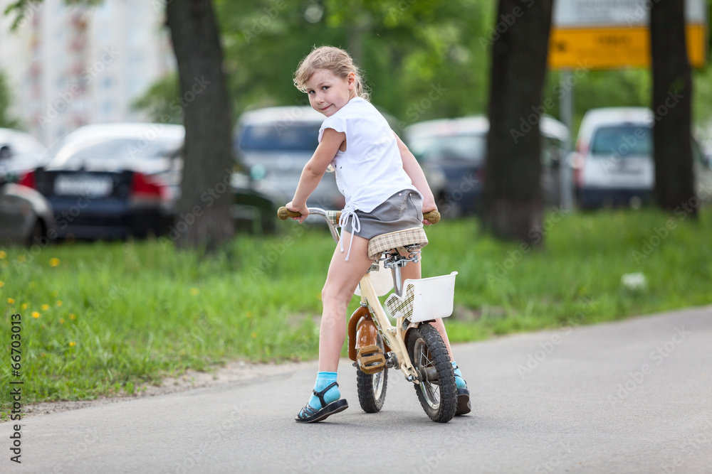 Happy girl riding a bicycle Happy girl riding a bicycle