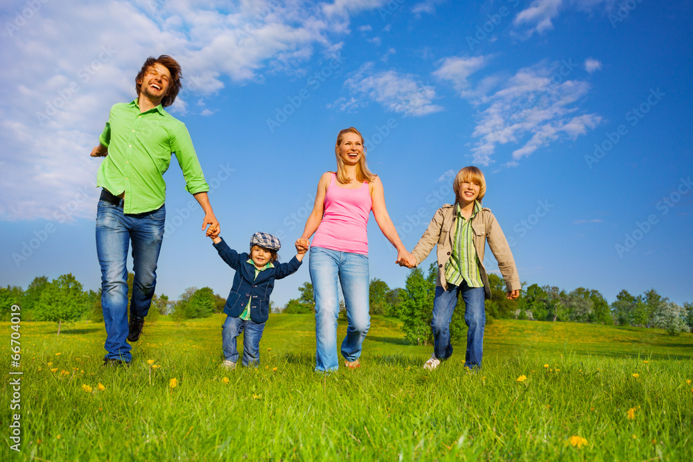 Cheerful parents walking with boys in park Cheerful parents walking with boys in park