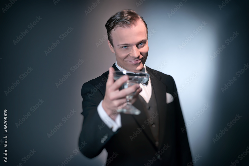 Smiling retro 1920 business fashion man holding champagne glass. Smiling retro 1920 business fashion man holding champagne glass.