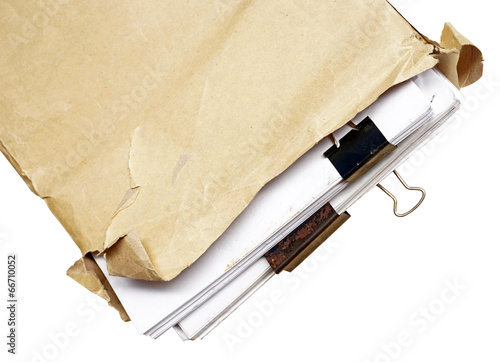 old folder with stack of old papers isolated on white