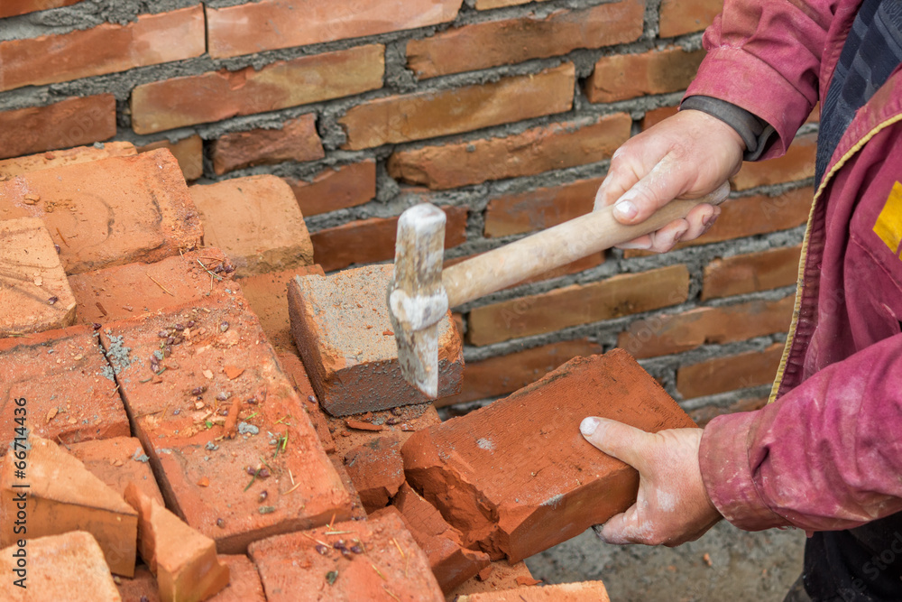 Builder worker cutting a brick 2 Builder worker cutting a brick 2