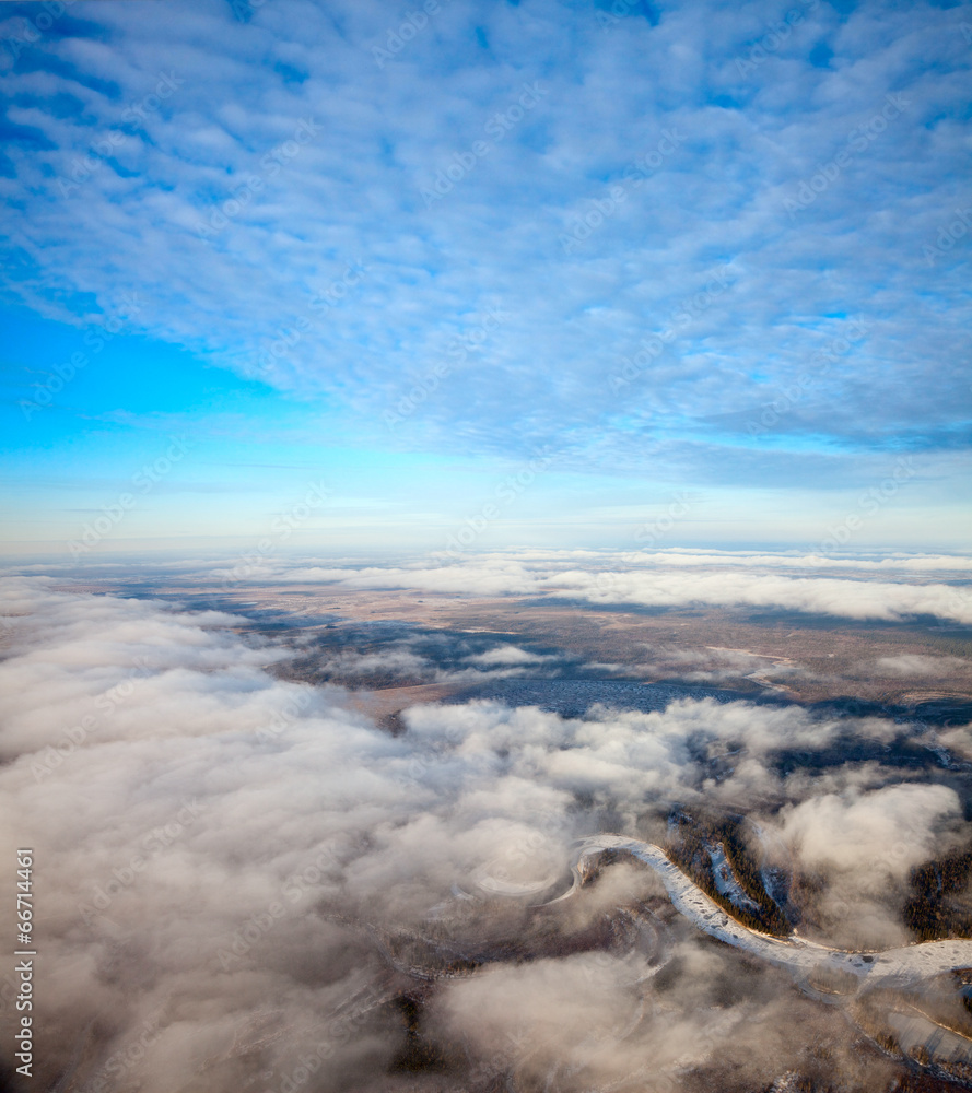 Flight between clouds, over uninhabited areas