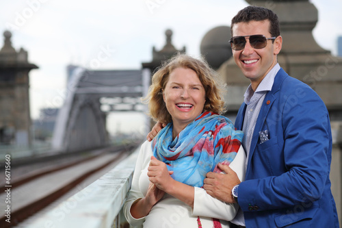 Pregnant woman in white and stylish man laugh