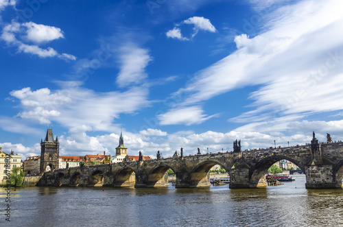 Charles bridge in Prague against a blue sky with clouds © Magdalena Kowalik