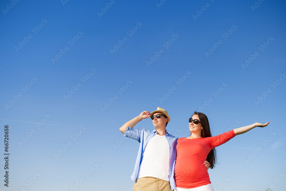 Pregnant couple with blue sky