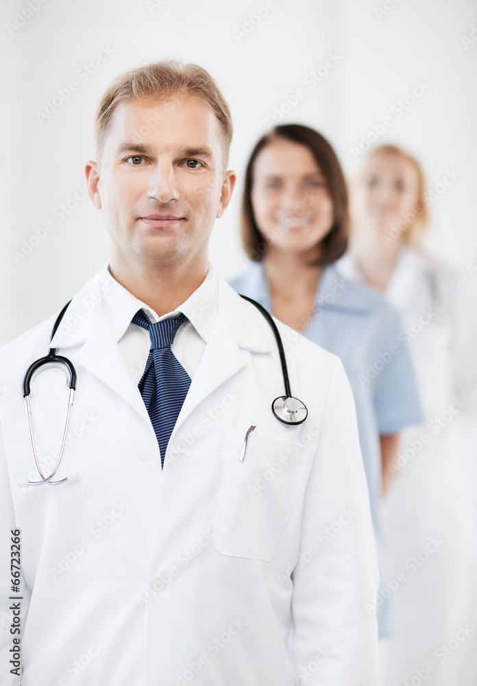 Fototapeta premium doctor with stethoscope and colleagues