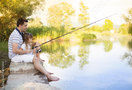 Happy father and daughter fishing