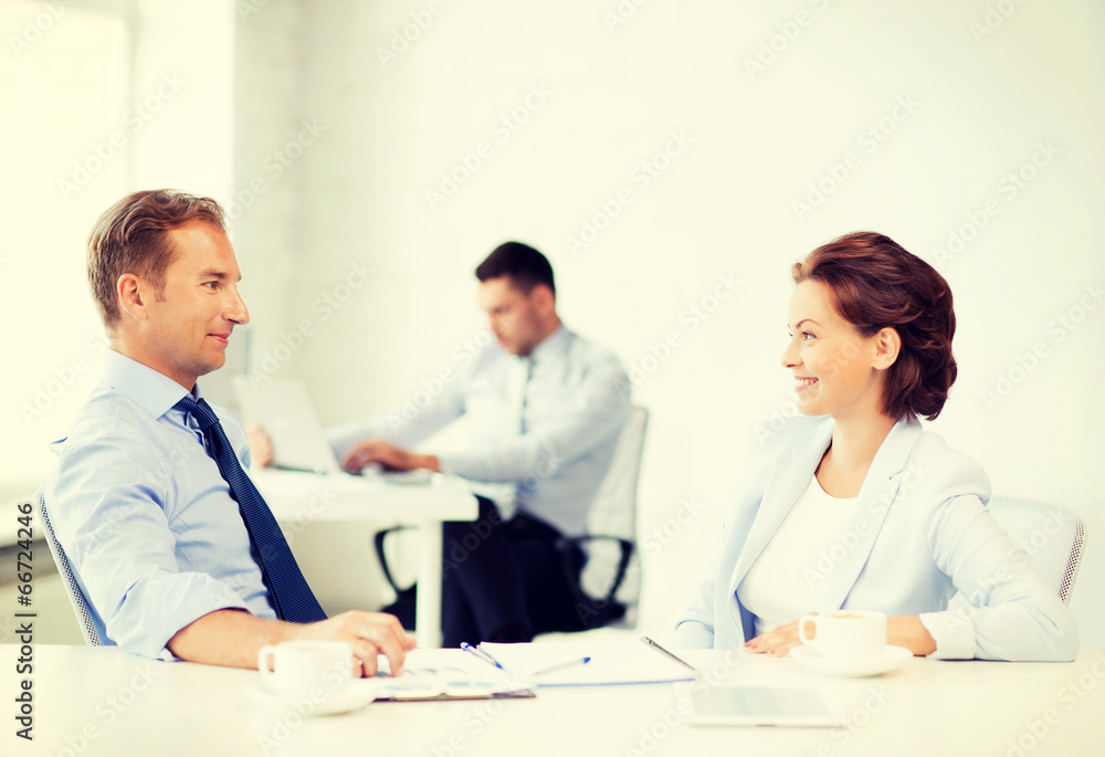 man and woman discussing something in office man and woman discussing something in office