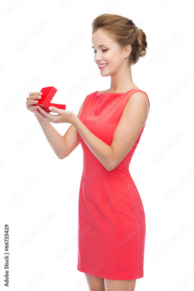 smiling young woman in red dress with gift box smiling young woman in red dress with gift box