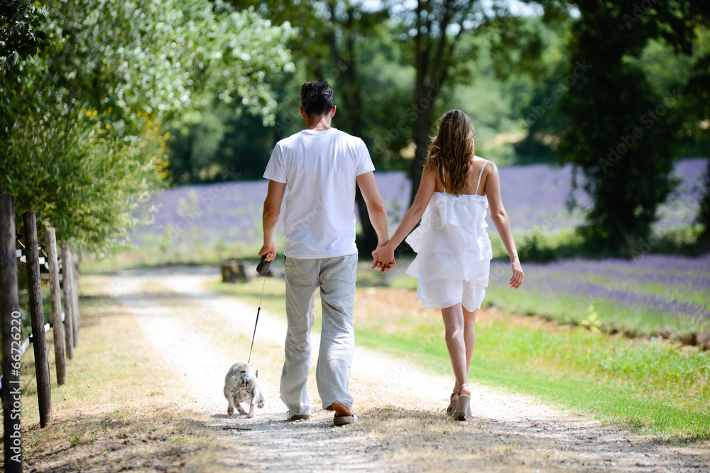young happy man woman couple walking with dog summer vacation young happy man woman couple walking with dog summer vacation