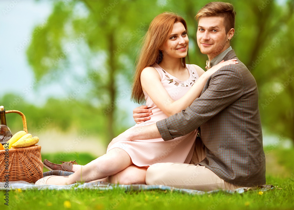 Couple in love in sitting near the river picnic. Valentine's Day Couple in love in sitting near the river picnic. Valentine's Day