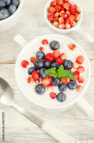 oatmeal with blueberries and strawberries in the white bowl