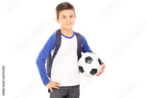 Kid with backpack holding a football © Ljupco Smokovski