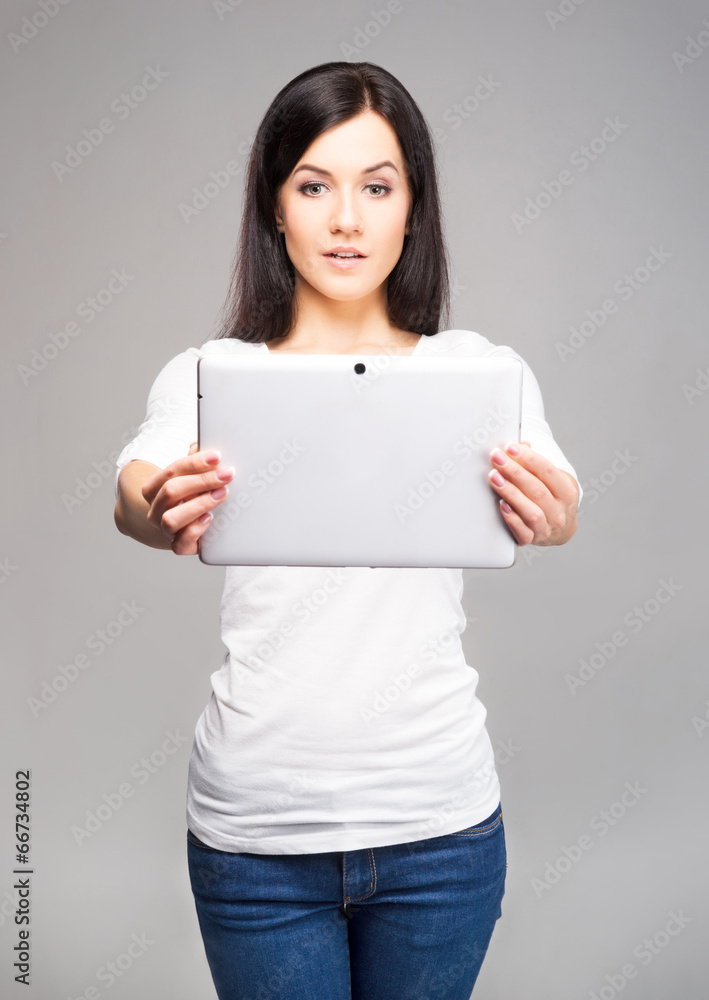 Young and beautiful teenager girl holding an ipad Young and beautiful teenager girl holding an ipad