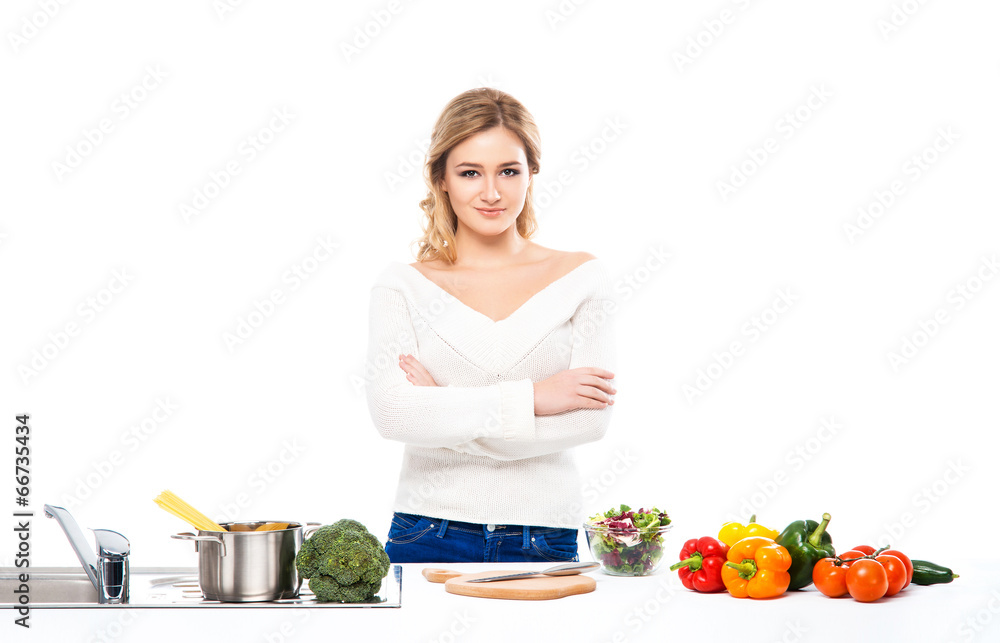 Young and beautiful housewife woman cooking in a kitchen