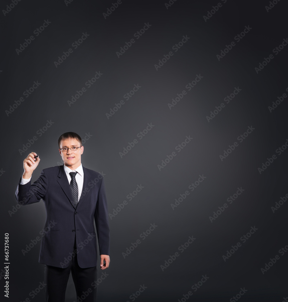 Successful and smart businessman writing imaginary text over gre Successful and smart businessman writing imaginary text over gre