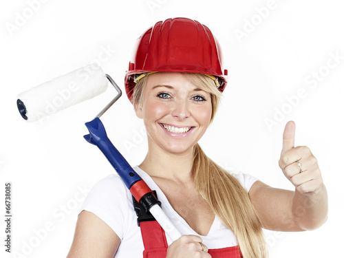 Apprentice with paint roller shows thumb up