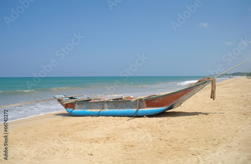 Exotic fisherman boat on beach near the ocean