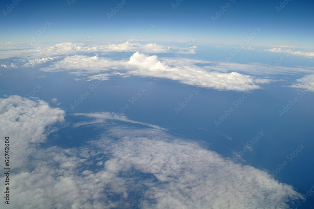 Fototapeta premium clouds and blue sky seen from plane
