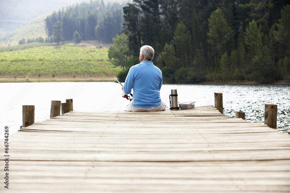 Senior man fishing on jetty