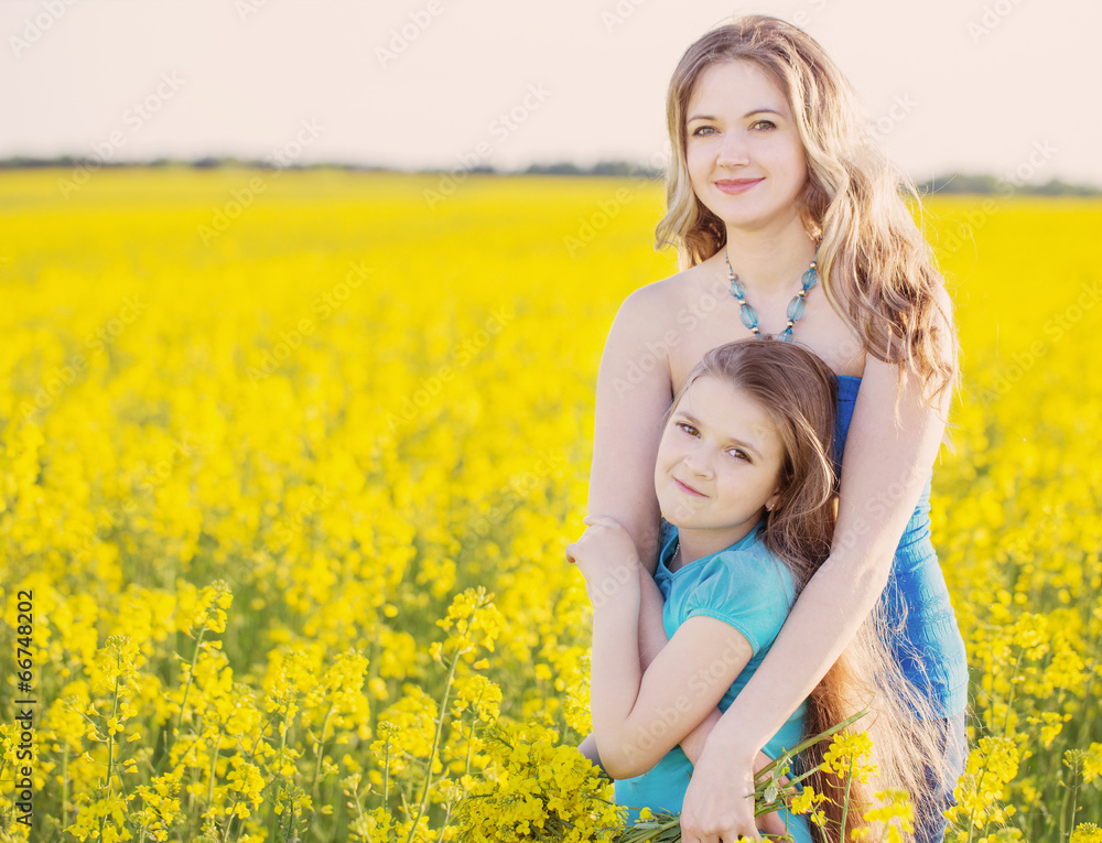 happy women and girl in rape field happy women and girl in rape field