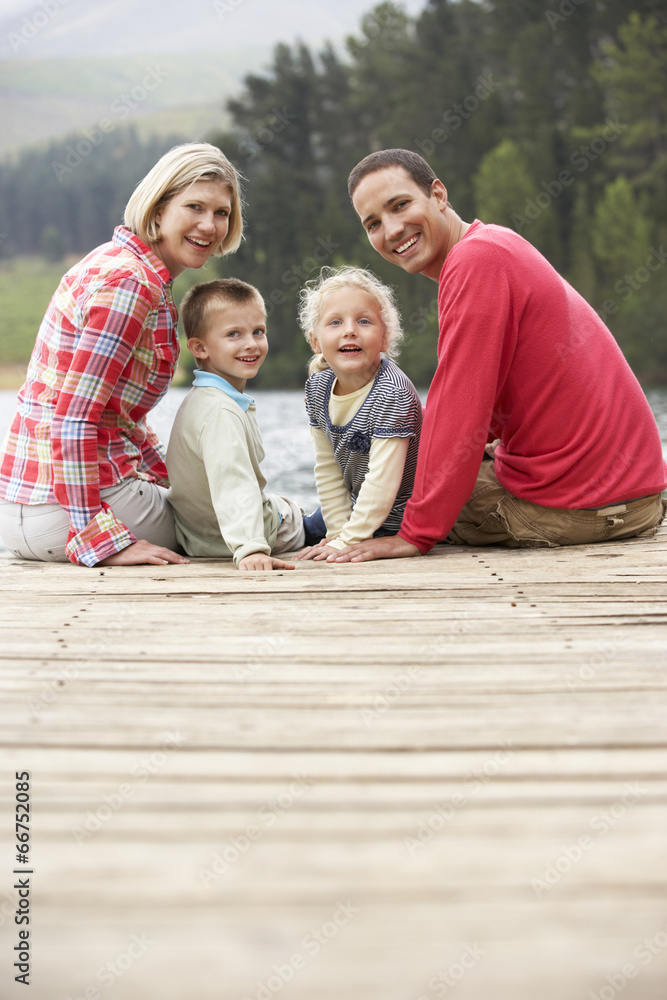 Family sitting on a jetty Family sitting on a jetty