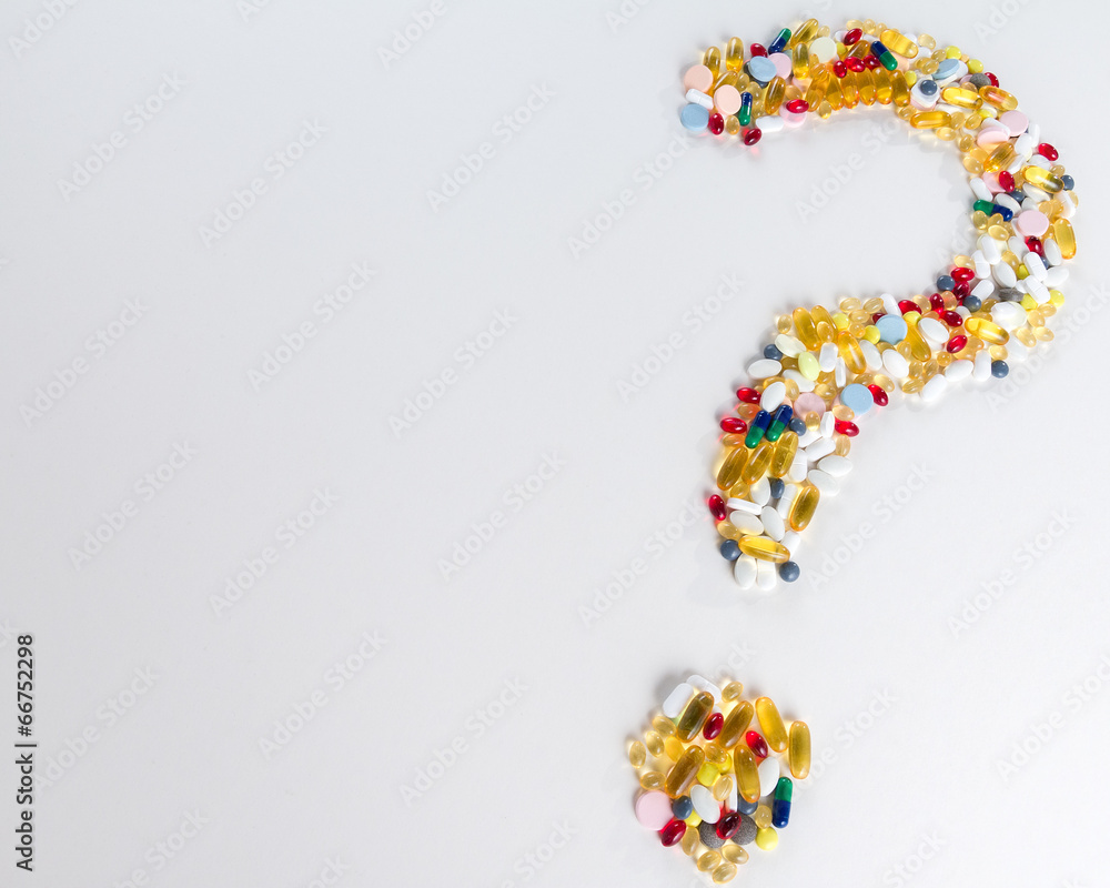 Pills as question mark on white background with copy space Pills as question mark on white background with copy space