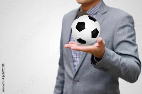 Fototapeta Naklejka Na Ścianę i Meble -  Football business concept, Ball in hand