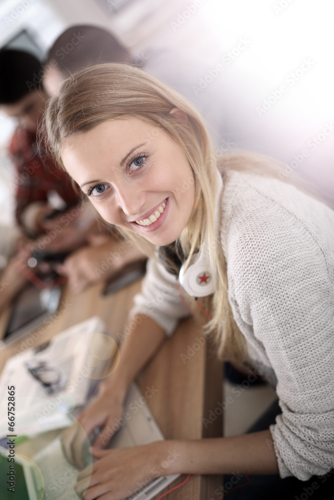 Student girl sitting in class and working on laptop Student girl sitting in class and working on laptop