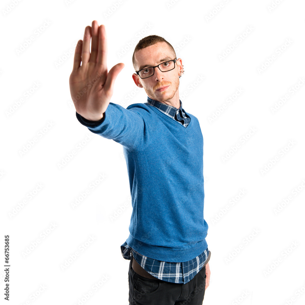 Young man doing stop sign over white background Young man doing stop sign over white background