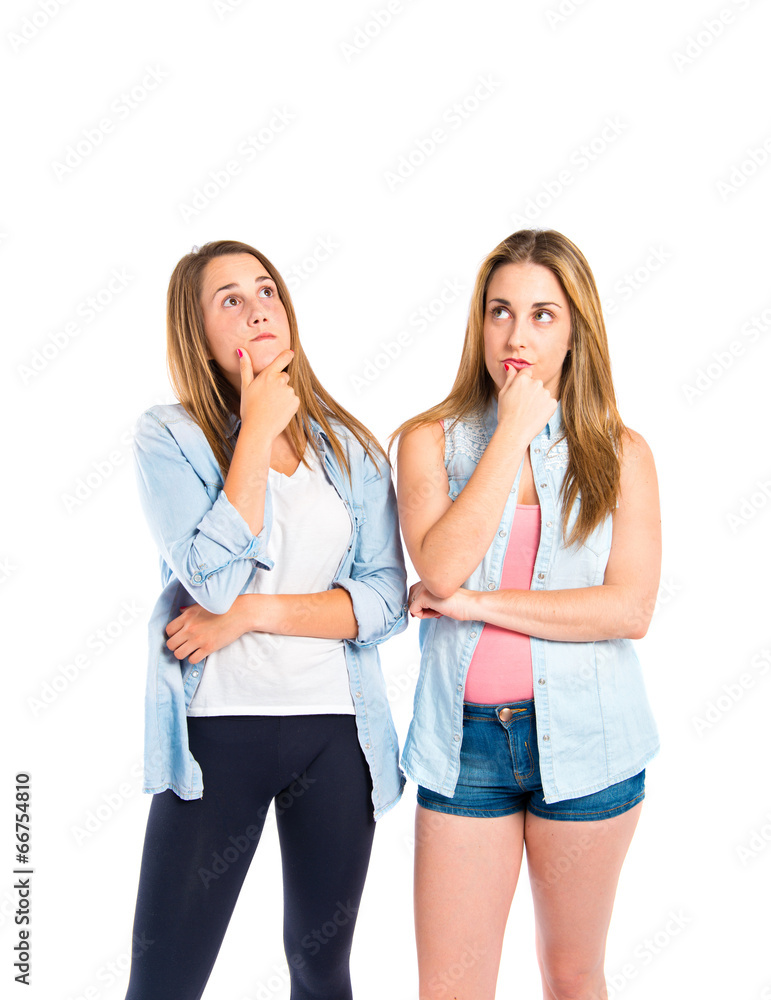 Girls thinking over isolated white background Girls thinking over isolated white background