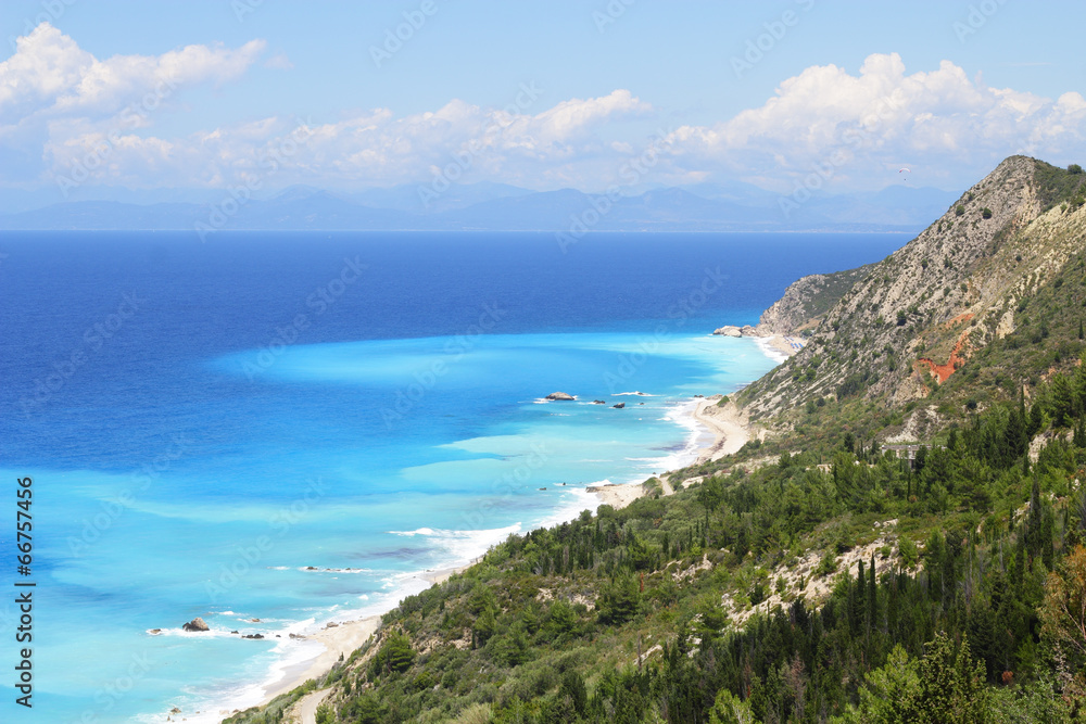 Beautiful turquoise sea and coastal hills with trees on the isla