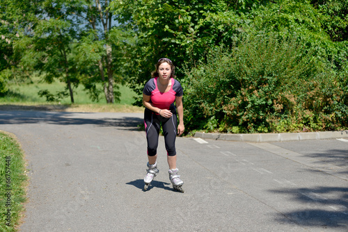 pretty young woman doing rollerskate on a track © Philipimage
