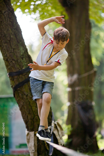 Little boy balancing on a tightrope