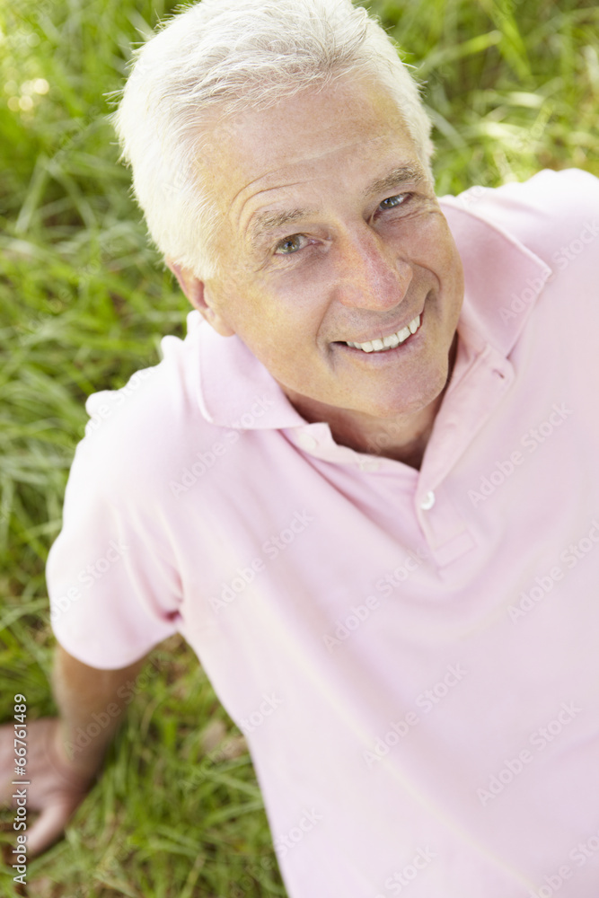 Senior man sitting on grass Senior man sitting on grass