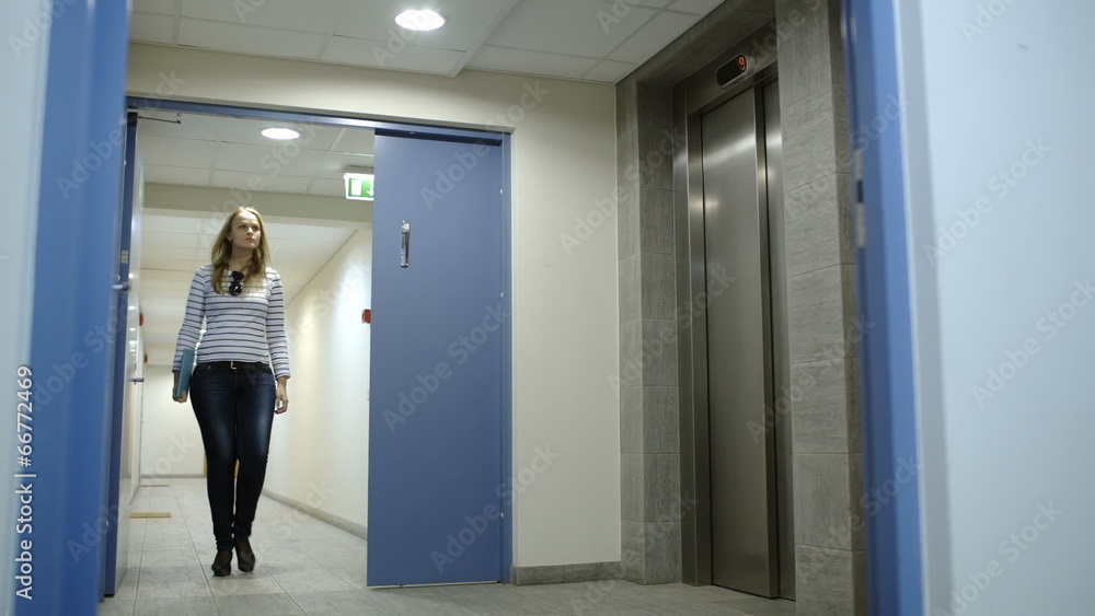 Young woman calling and waiting for elevator Young woman calling and waiting for elevator