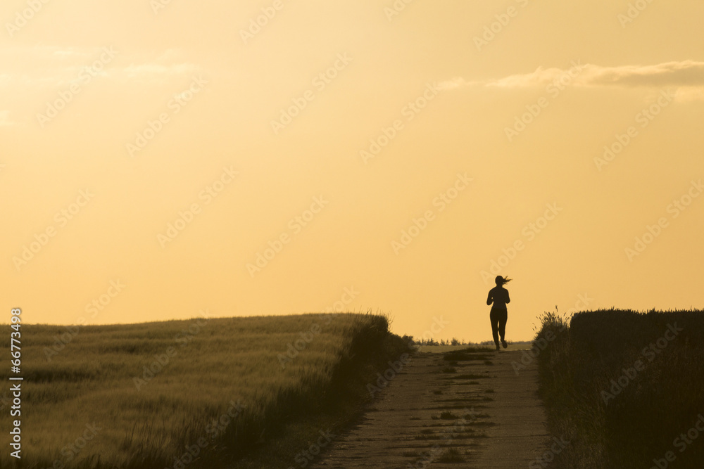Silhouette of young woman running