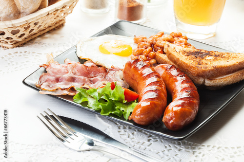 Full English breakfast with bacon, sausage, egg and baked beans