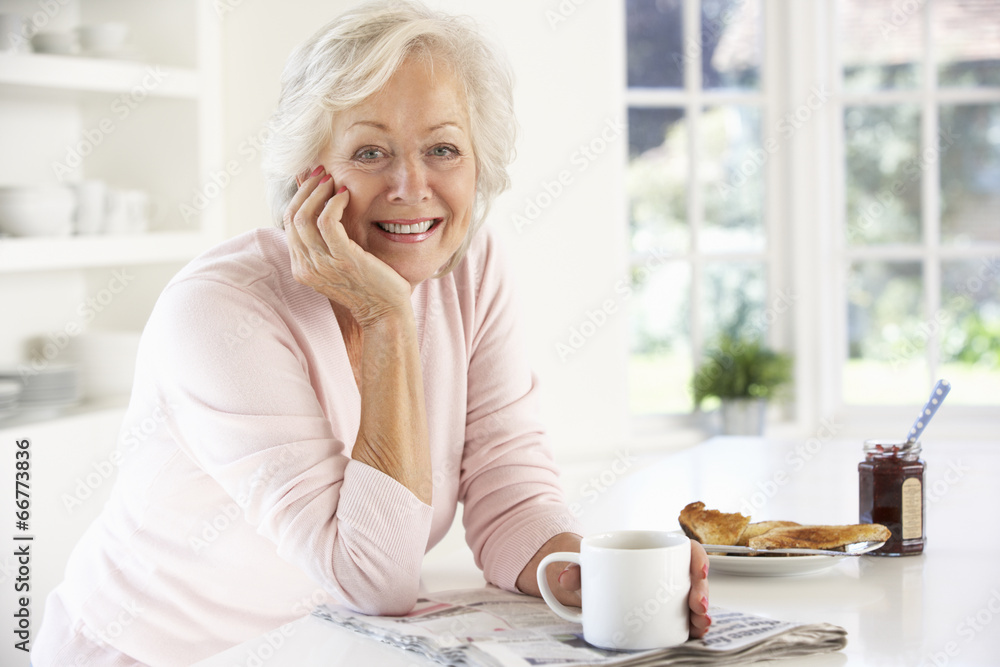 Retired woman eating breakfast Retired woman eating breakfast