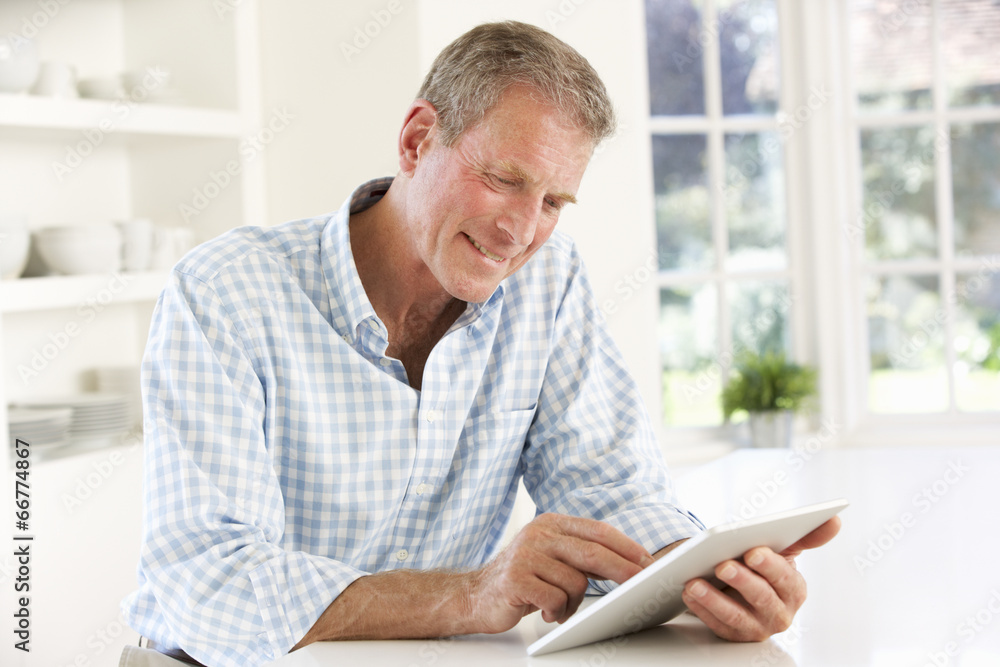 Senior man using tablet at home Senior man using tablet at home