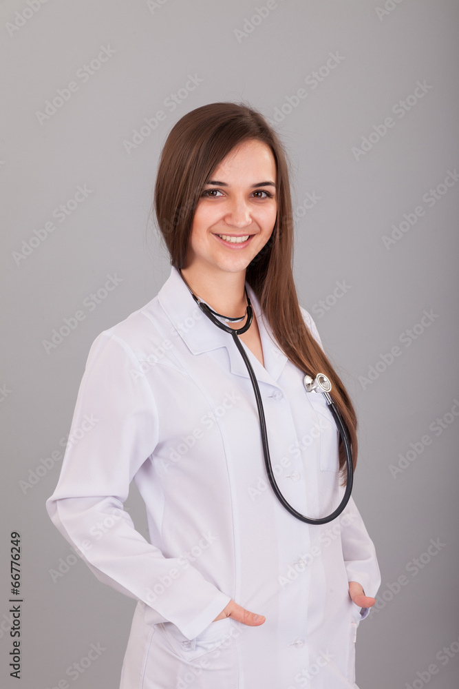 Young and beautiful nurse on a grey Young and beautiful nurse on a grey