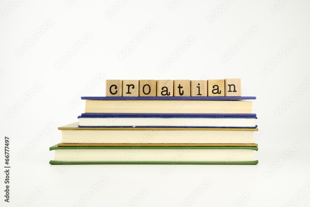 Naklejka premium croatian language word on wood stamps and books