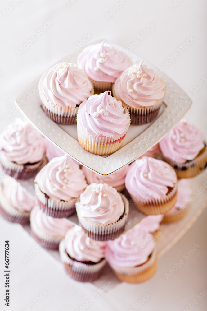Pink cupcakes at white table  in high light style.