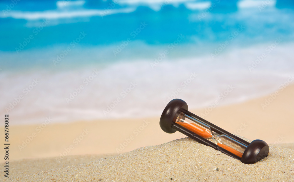 Hourglasses on a sandy beach Hourglasses on a sandy beach