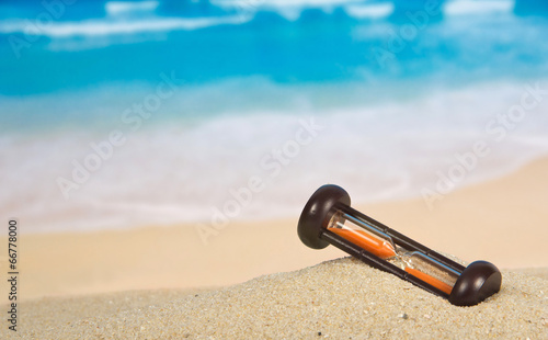 Hourglasses on a sandy beach