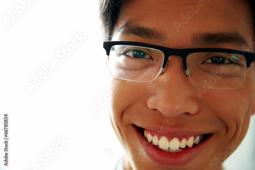 Closeup portrait of a happy asian man in glasses