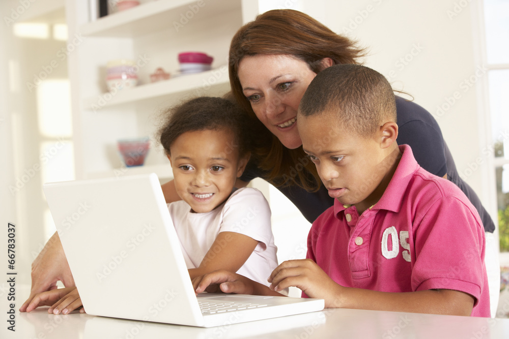 Mother and Downs Syndrome son with laptop Mother and Downs Syndrome son with laptop