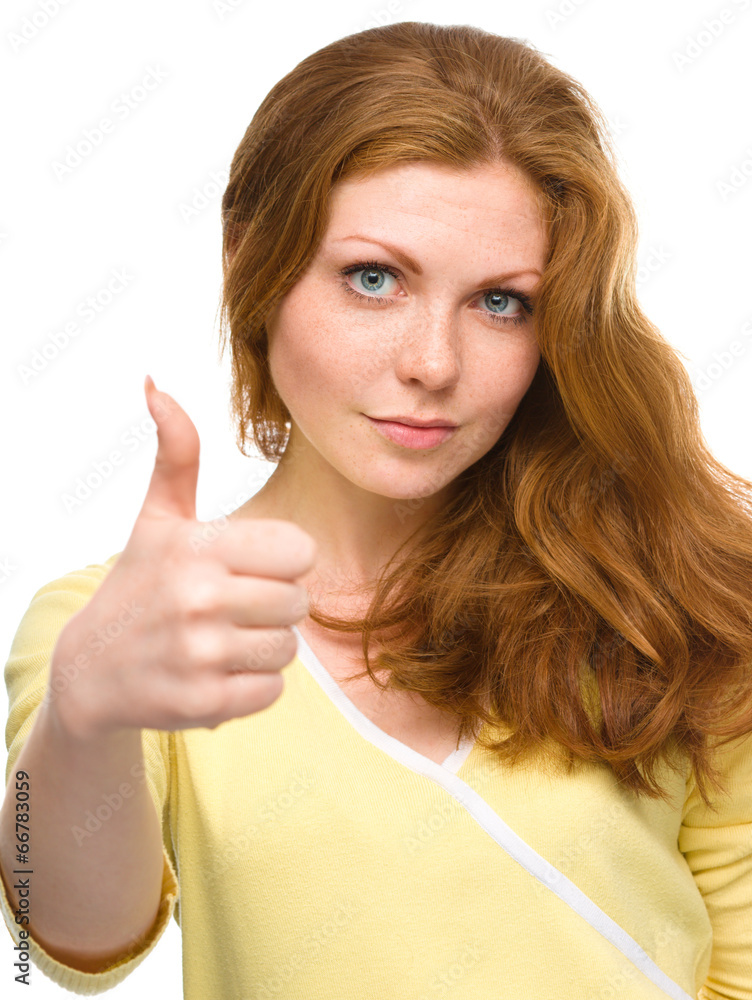 Woman is showing thumb up gesture Woman is showing thumb up gesture
